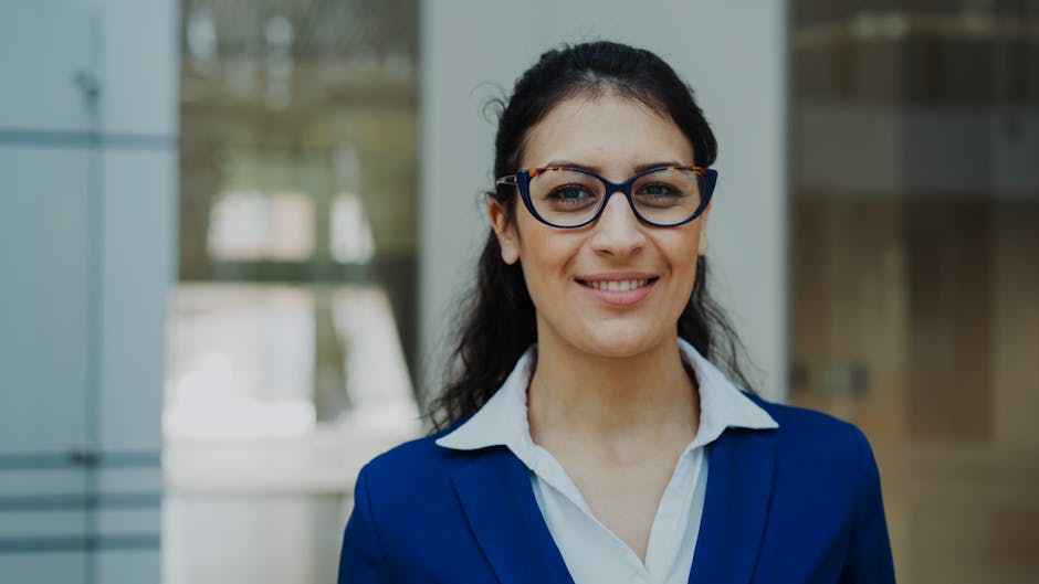 Portrait of a confident businesswoman in a blue suit standing indoors