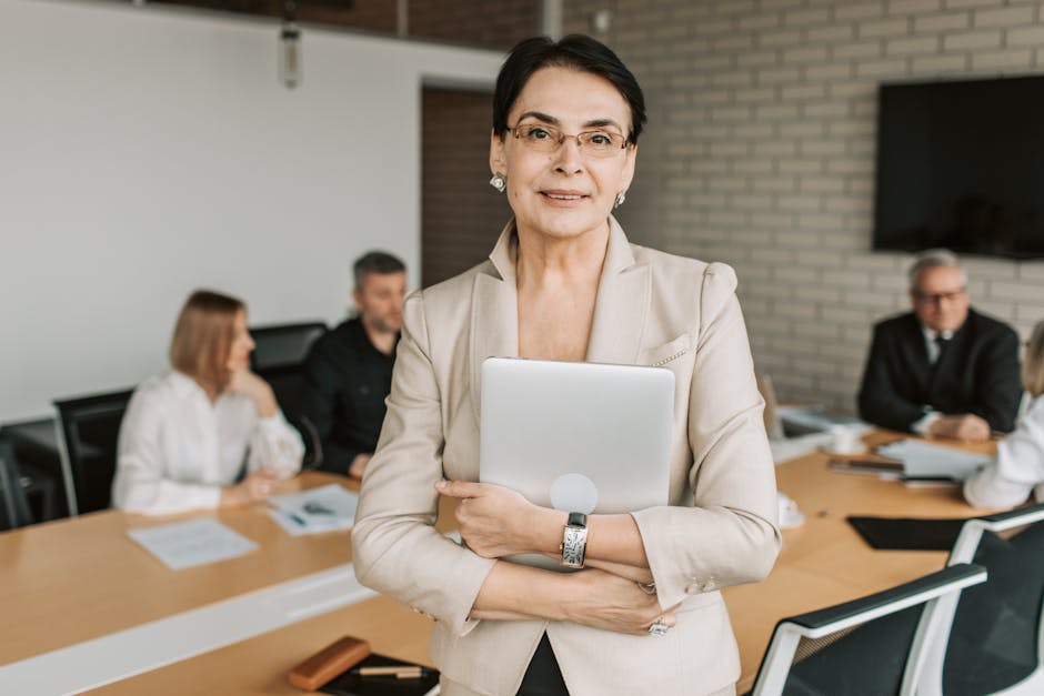 Professional businesswoman holding a tablet in a corporate meeting setting